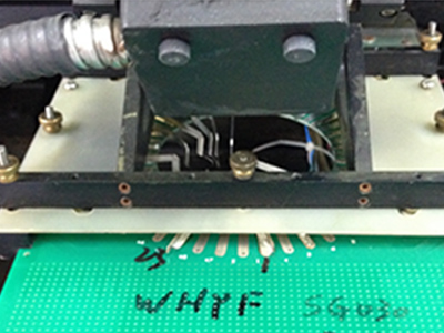 The jig board is inserted into the laser resistor trimming instrument.